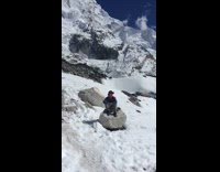 Woman with hat films video at Himalayas