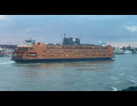 Ferry passing underneath hells gate bridge