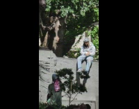 3 guys sit on monument 