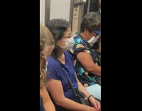 Woman uses a napkin as a mask on subway