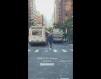 Guy in silver helmet in blue suit on scooter