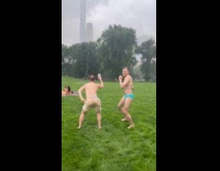 Shirtless guys showers in rain at park