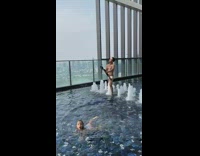 Guy white trunks tripod selfie indoor pool