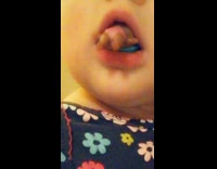 Little girl filter flower shirt toy in mouth