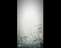 Guy wears white cloth riding surfboard 