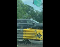 Person in clown mask sits inside car 
