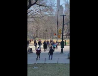 Person in spiderman outfit interacting with kids on crosswalk