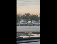 Guy runs across street with beer 