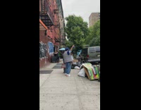 2 guys dance to 70s music on sidewalk 