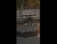 Guy on pre workout benching white table outside 