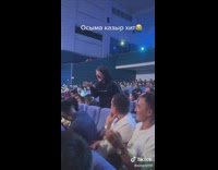 Woman from the crowd in the auditorium dances