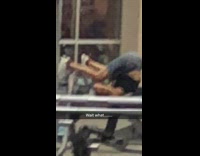 man in black shorts legs up at gym