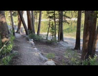 Guy walks to lake mountain fishing rod 