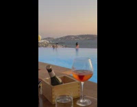 Woman white bikini lean on poolside man camera stabilizer