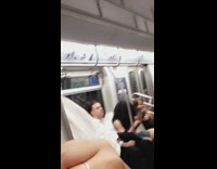 Guy pretends to play the drums and head bangs on subway train