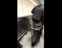 Guy goes down broken escalator with biker 