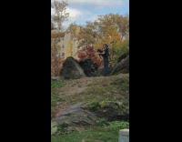 Black shirt guy plays bagpipes grass