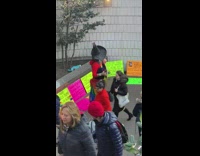 Guy sings I will survive and protests against Donald Trump with rainbow pride flag