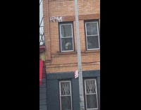 Guy sees shiny reflection in apartment window 