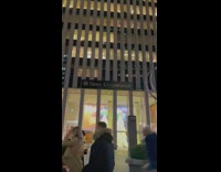 Tiny Christmas tree lights up Times Square
