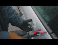 Man use tool to open frozen car door