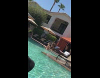 Woman red bikini walk up pool stairs