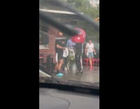 Guy big helmet causally talking on sidewalk