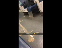 Brown liquid spills down aisle on subway train