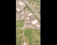 Flying airplane shadow casted on land below