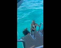 Collab ClipsIG - Woman falls into ocean water right after climbing onto boat 