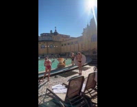 Woman in pool reviews photo from photoshoot