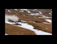 Small avalanche on mountain blocks the road