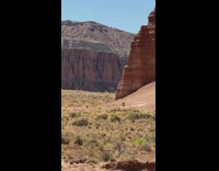 Shirtless guy barbel deadlift sunny desert mountain