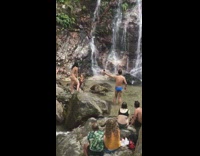 People take photo by waterfall 