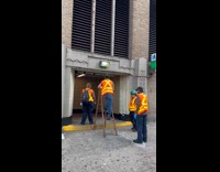 MTA worker climb ladder to change lights