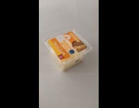 Filmer flips plastic box of cheese repeatedly