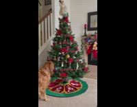 Dog steals ornament toy from Christmas tree