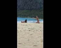 Girl beach blonde friend adjusts butt for better photo