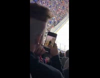 Guy analyzes photos at hockey game 