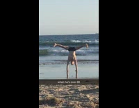 Guy does handstand at beach
