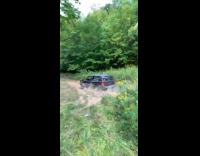 Black jeep car does a jump off a hill
