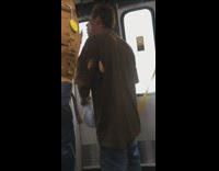 Guy tell bus operator to open door, tackles and forces door to open