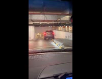 Person drives car stuck on underground divider