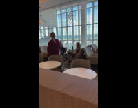 Woman inside the airport with her parrot in the morning 