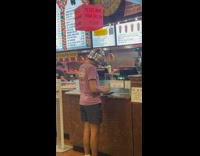 Man wears robot helmet in the counter and counts money