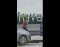 Man in brown sweater tiktok dance on the sidewalk