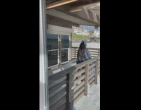 Woman black top selfie outside beach office