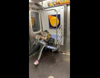 Lady wears plastic shield over gas mask 