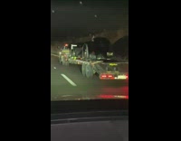 Truck carry batmobile on back freeway night