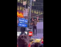 Guy does pull ups on street light